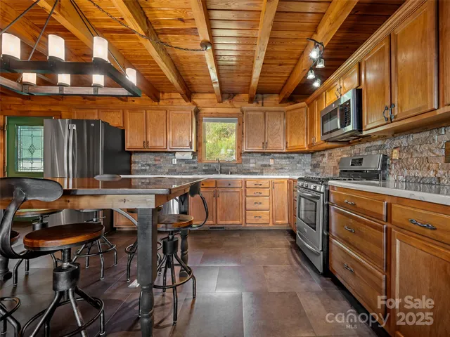 a kitchen with stainless steel appliances granite countertop a sink stove and microwave