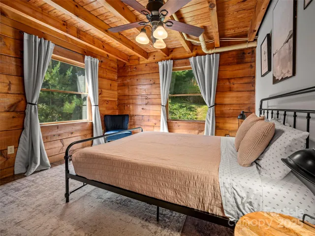 a bedroom with a large bed and a chandelier