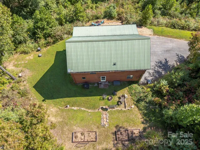 an aerial view of a house with a yard