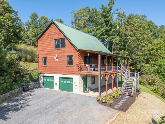 a view of a house with a yard and potted plants