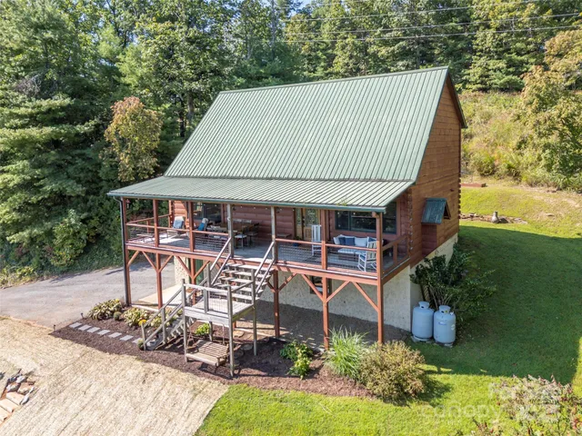 an outdoor view of house with swimming pool and garden