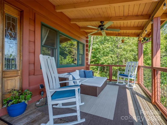 a view of a patio with table and chairs potted plants with wooden floor