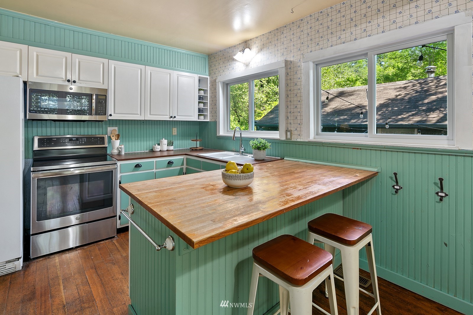 18416 Southeast Petrovitsky Road Renton, WA 98058 - Photo 12 of 36 a kitchen with stainless steel appliances granite countertop a table chairs stove and refrigerator