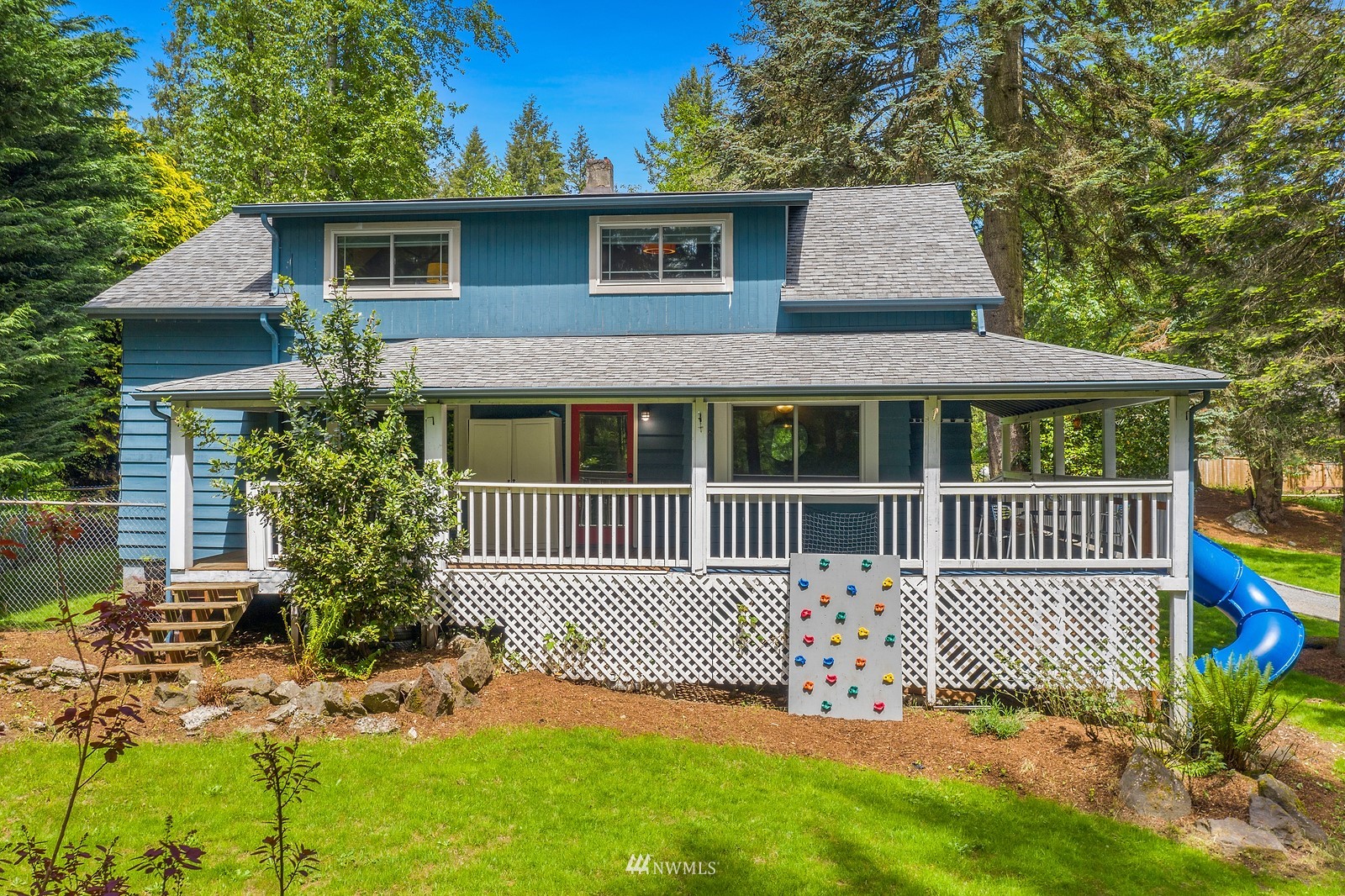 18416 Southeast Petrovitsky Road Renton, WA 98058 - Photo 2 of 36 a view of a house with a small yard and wooden fence