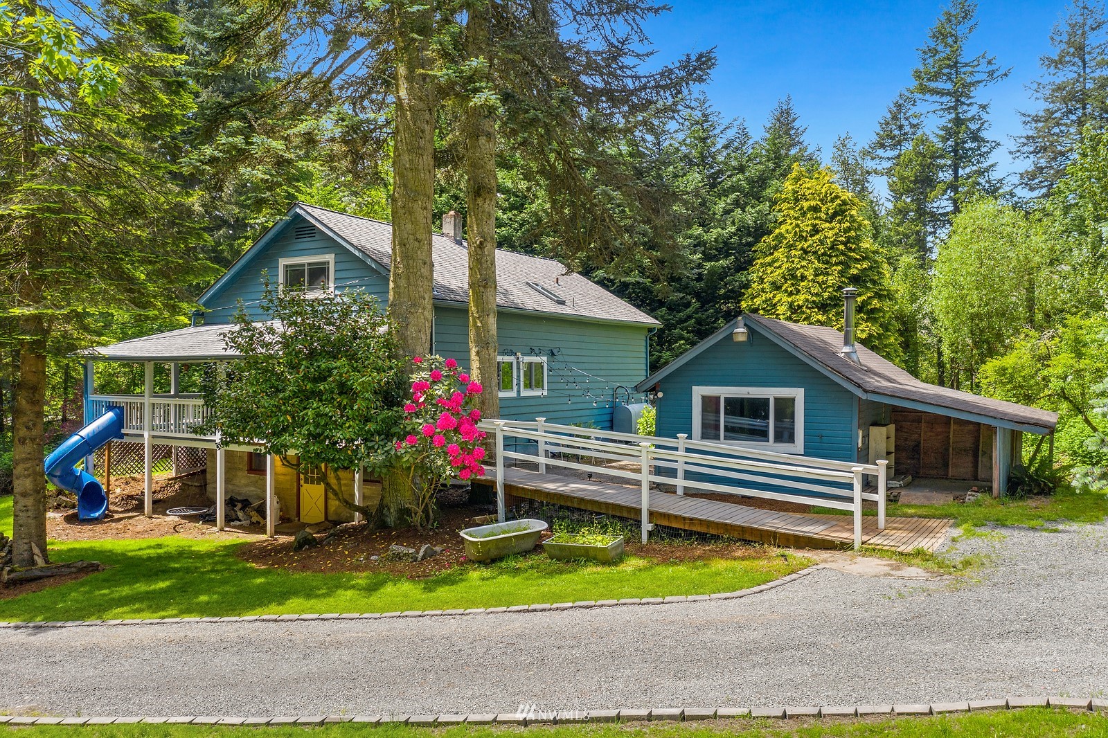 18416 Southeast Petrovitsky Road Renton, WA 98058 - Photo 4 of 36 a front view of a house with a yard and garage