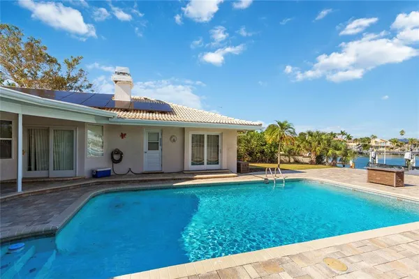 a large kitchen with stainless steel appliances lots of counter space and a sink