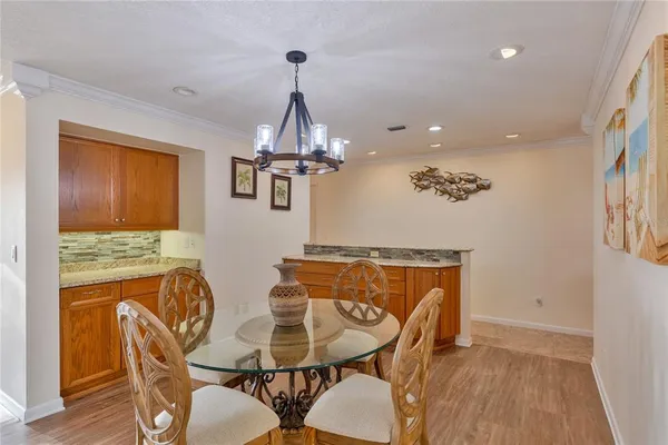 a bathroom with a granite countertop toilet a sink and a mirror