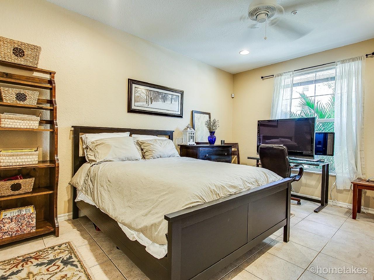 4308 Blowing Point Place Jupiter, FL 33458 - Photo 16 of 21 a bedroom with a bed and a flat screen tv