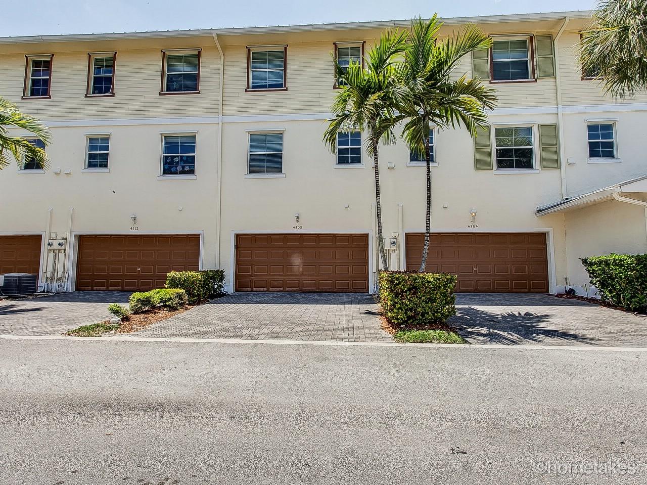4308 Blowing Point Place Jupiter, FL 33458 - Photo 19 of 21 a front view of a house with a yard and garage