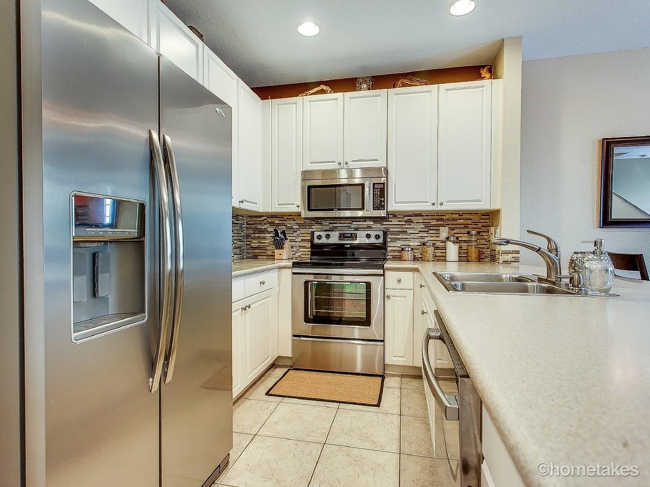 4308 Blowing Point Place Jupiter, FL 33458 - Photo 8 of 21 a kitchen with a refrigerator sink and microwave
