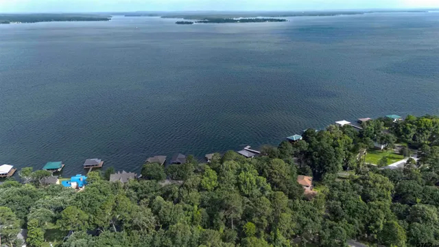 an aerial view of a house with yard swimming pool and outdoor seating
