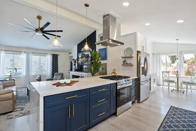 a kitchen with stainless steel appliances a sink stove and refrigerator