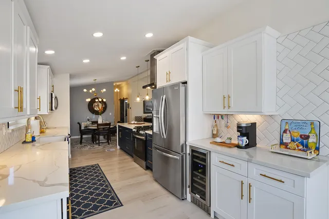 a kitchen with refrigerator and cabinets