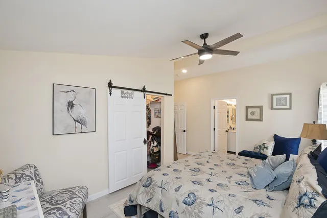 a bedroom with a bed and a painting on the wall