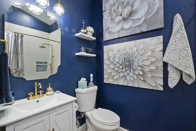 a bathroom with a toilet sink and mirror