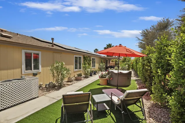 a view of a backyard with patio and outdoor seating