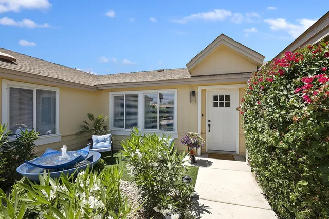 a view of a house with chair and table in the patio