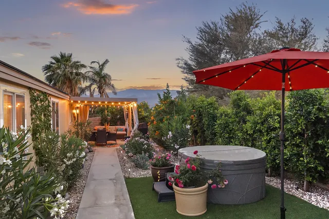an outdoor space with furniture and umbrella