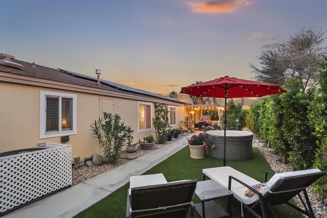 a view of a house with a backyard and a garden