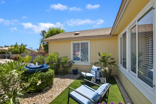 a backyard of a house with outdoor seating