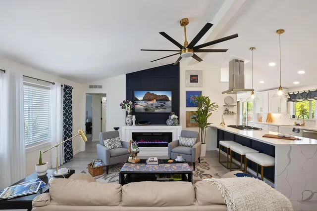 a living room with furniture fireplace and a window