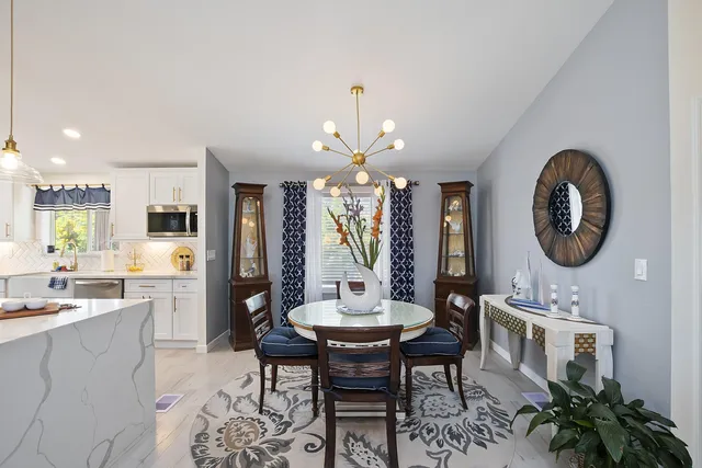 a view of a dining room with furniture and a large window