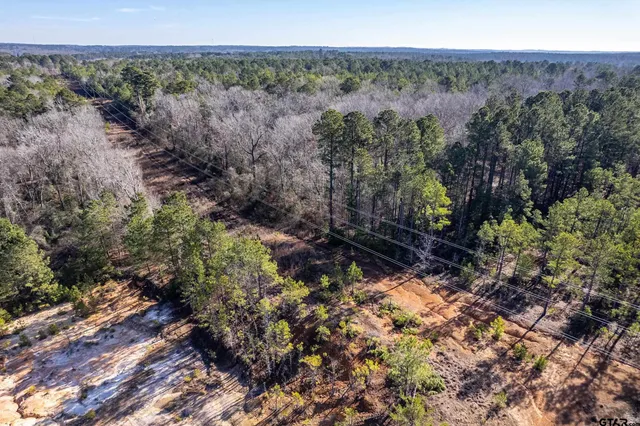 an aerial view of a house with a street