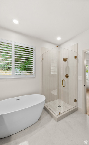 340 Brayden Way Draper, UT 84020 - Photo 22 of 58 Freestanding bathtub, glass-enclosed shower with gold-tone fixtures, white plantation shutters, recessed lighting, and light-toned floor tiling