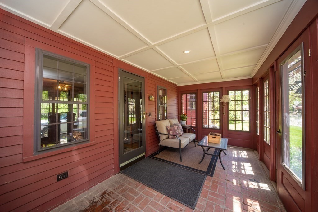 338 Neck Road Lancaster, MA 01523 - Photo 14 of 42 a living room with furniture and a floor to ceiling window