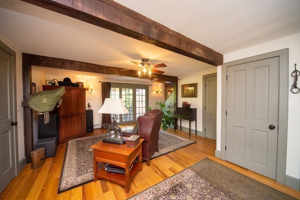 338 Neck Road Lancaster, MA 01523 - Photo 15 of 42 a room with lots of furniture and a chandelier