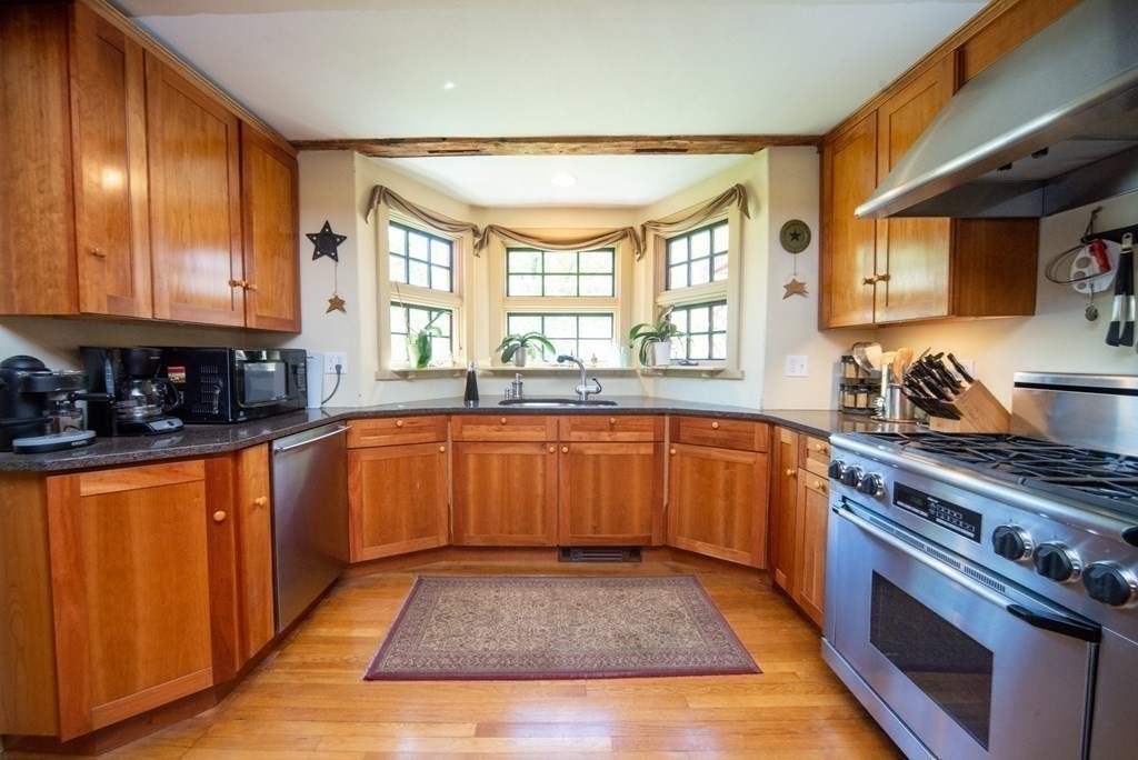 338 Neck Road Lancaster, MA 01523 - Photo 20 of 42 a large kitchen with stainless steel appliances granite countertop a stove a sink and a microwave