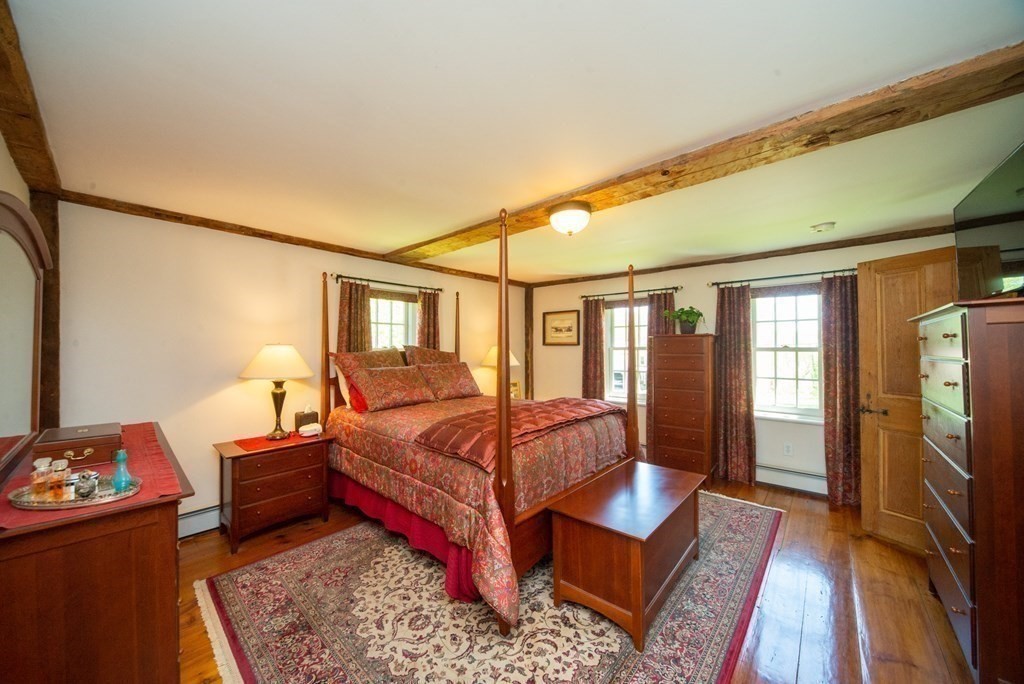 338 Neck Road Lancaster, MA 01523 - Photo 24 of 42 a bedroom with a bed and wooden floor