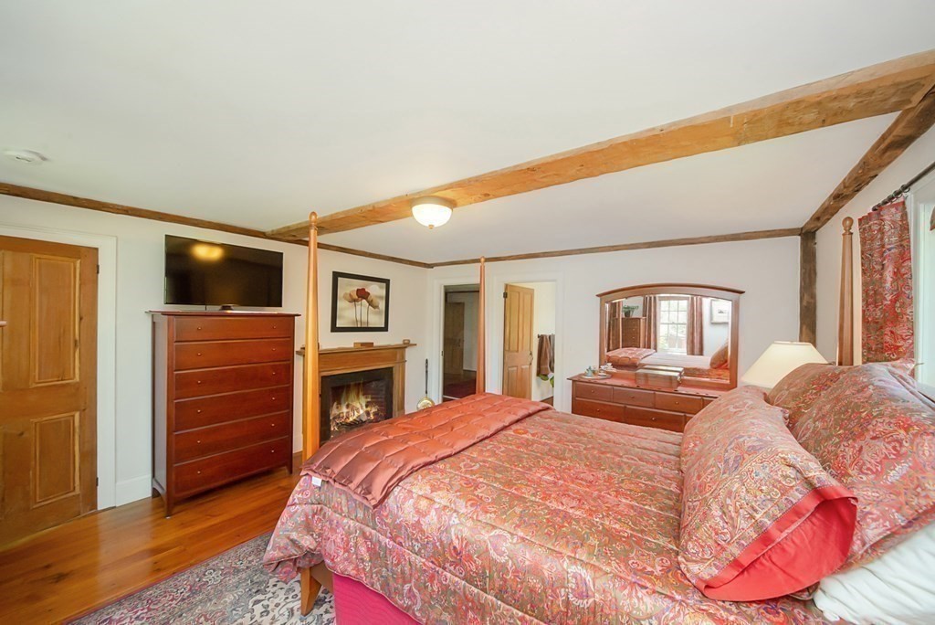338 Neck Road Lancaster, MA 01523 - Photo 25 of 42 a bedroom with a bed and a flat screen tv