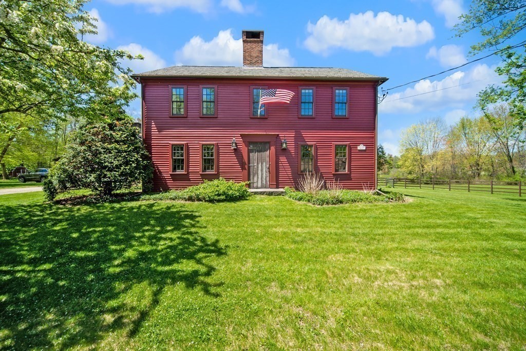 338 Neck Road Lancaster, MA 01523 - Photo 6 of 42 a view of a brick house with a yard