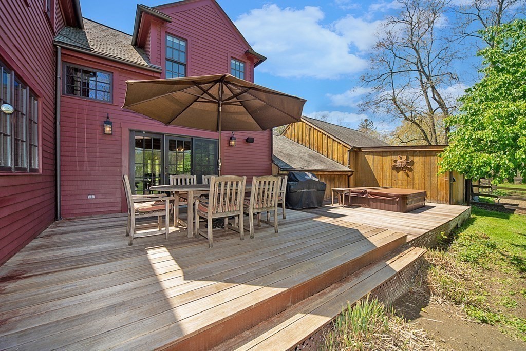 338 Neck Road Lancaster, MA 01523 - Photo 8 of 42 a view of a dinning table and chairs in patio of the house