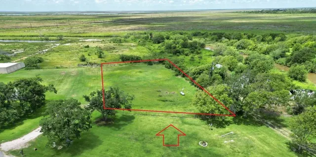 a view of a field with an ocean