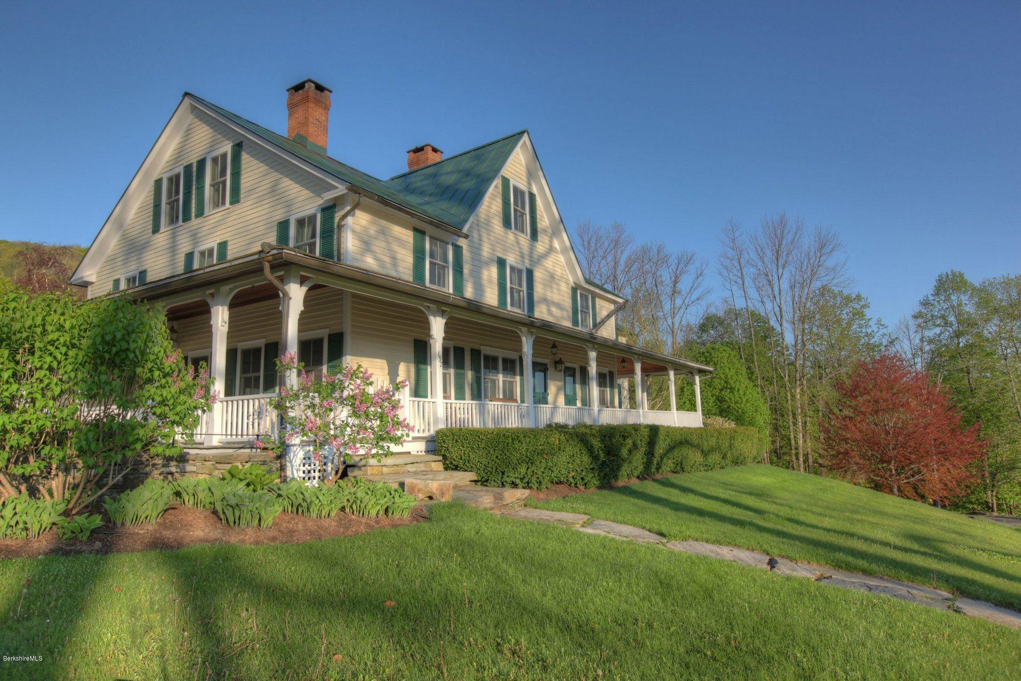 137 Jerusalem Road Tyringham, MA 01264 - Photo 2 of 59 a front view of a house with a yard table and chairs