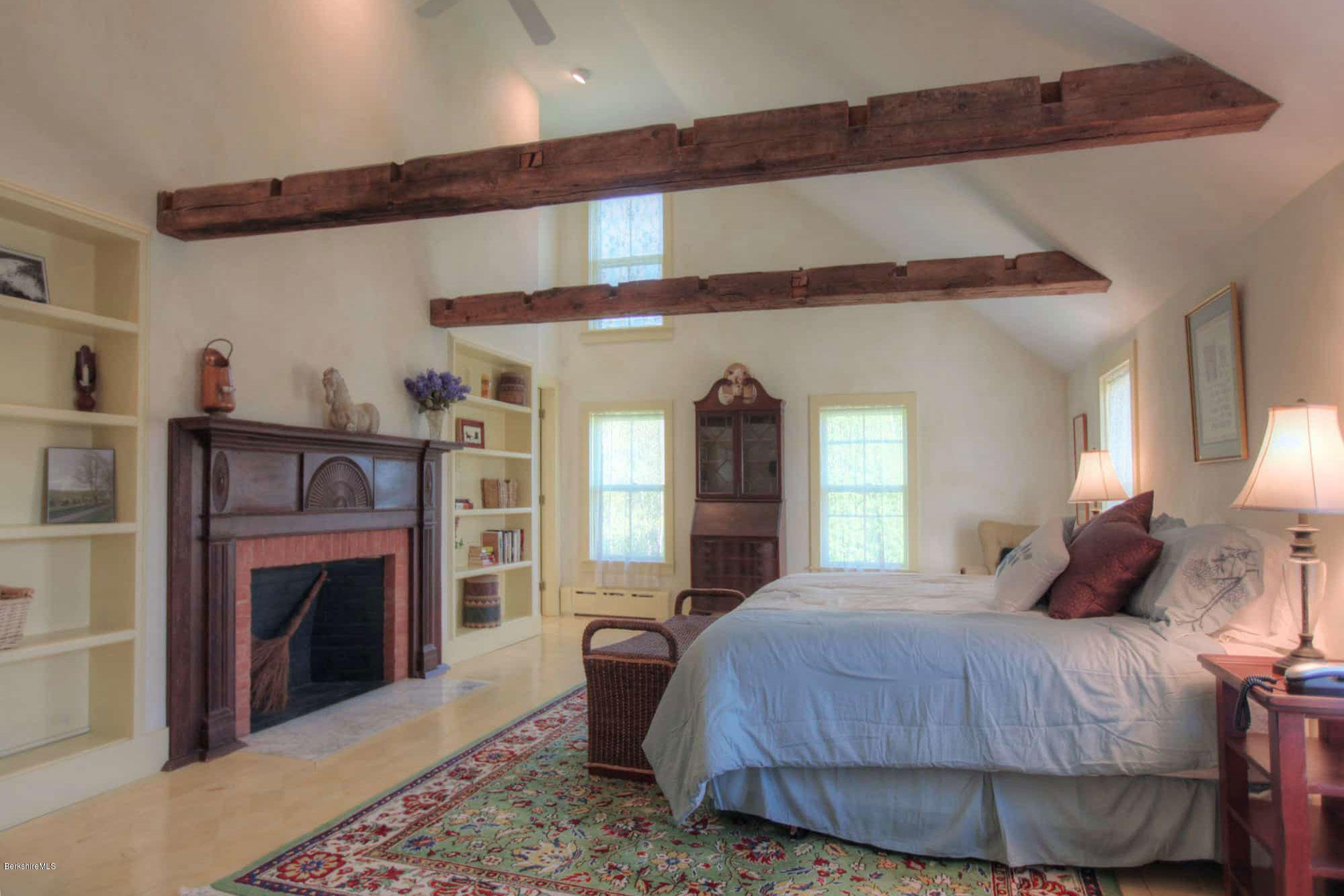 137 Jerusalem Road Tyringham, MA 01264 - Photo 15 of 59 a bedroom with a bed and a fireplace