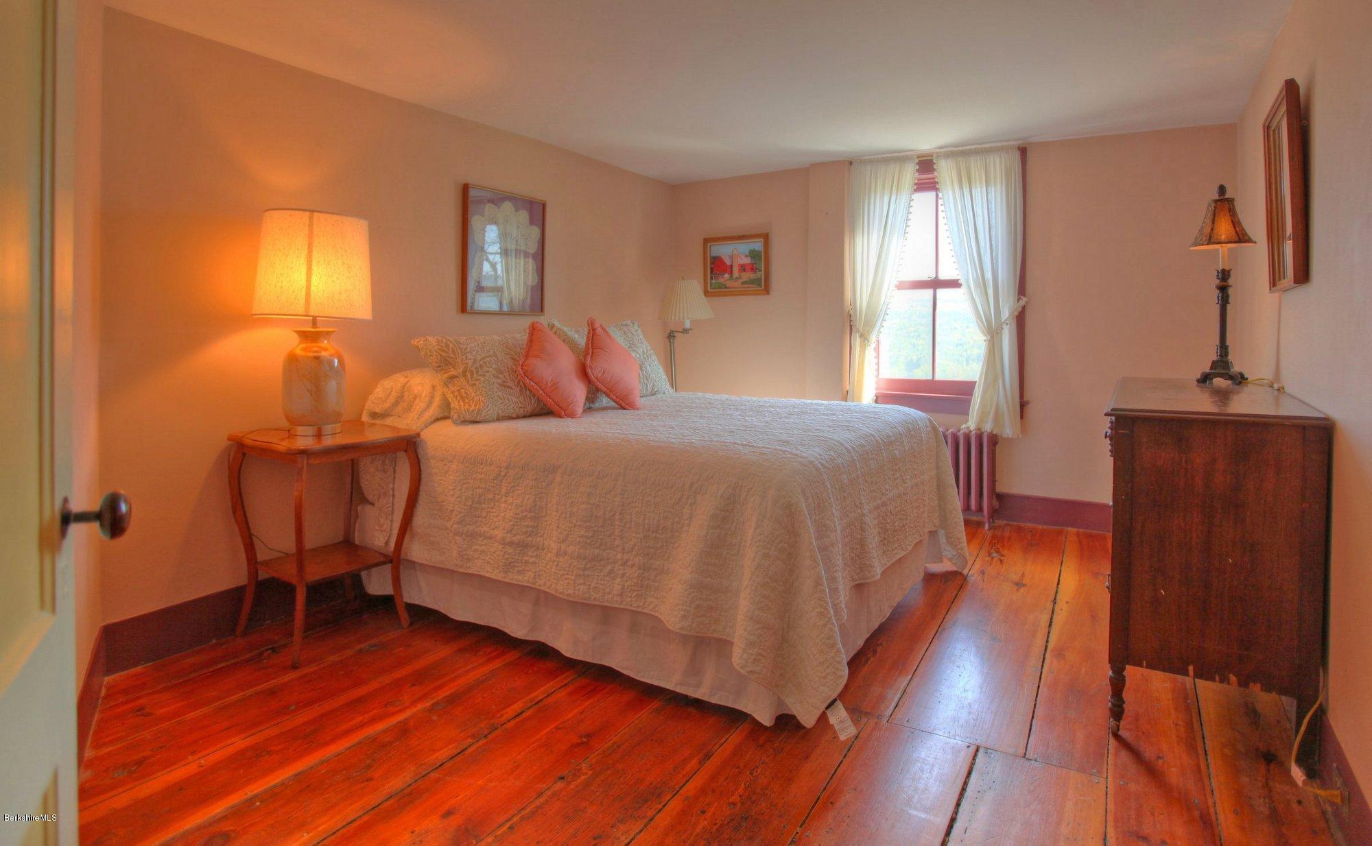 137 Jerusalem Road Tyringham, MA 01264 - Photo 32 of 59 a bedroom with a bed and wooden floor