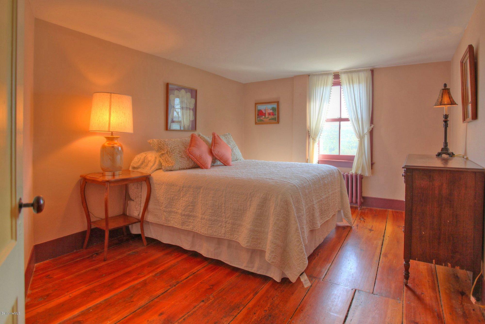 137 Jerusalem Road Tyringham, MA 01264 - Photo 33 of 59 a bedroom with a bed and wooden floor