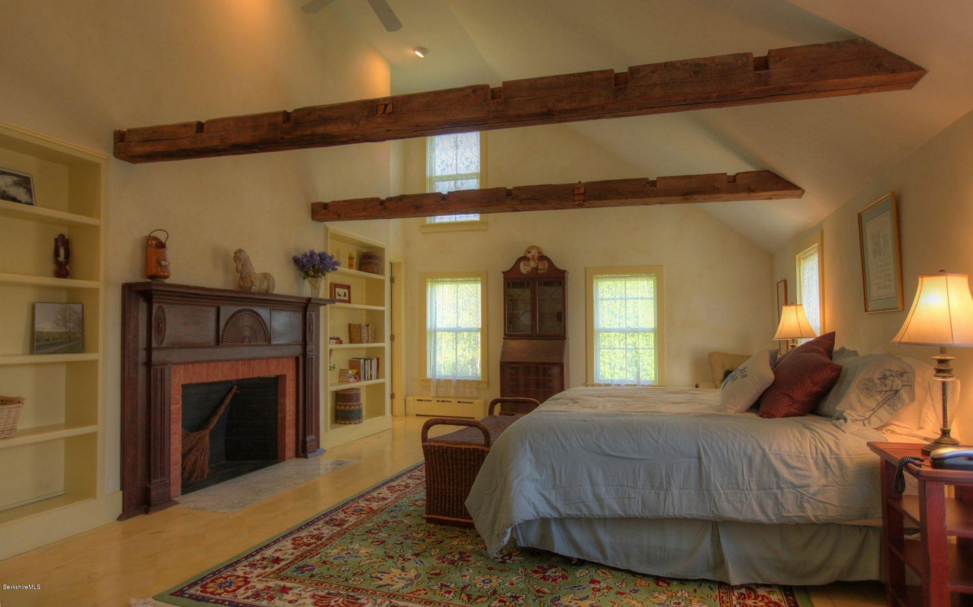 137 Jerusalem Road Tyringham, MA 01264 - Photo 35 of 59 a bedroom with a bed and a fireplace