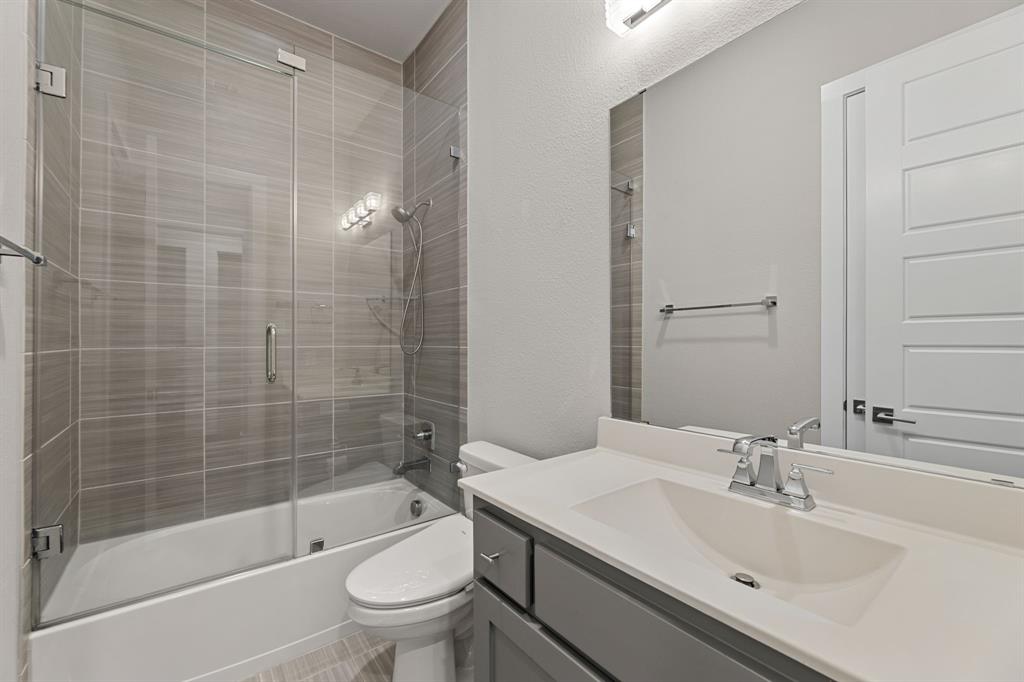 7854 Element Avenue Plano, TX 75024 - Photo 15 of 38 Full bathroom with vanity and shower / bath combination with glass door
