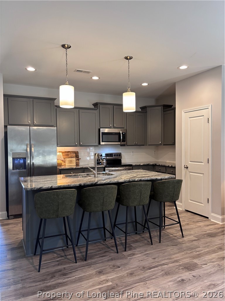 7720 Rufus Johnson Road Fayetteville, NC 28306 - Photo 17 of 50 a kitchen with a table chairs refrigerator and microwave