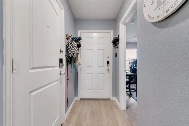 a front view of a house with a big yard and large trees