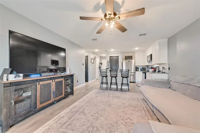 a open kitchen with stainless steel appliances kitchen island granite countertop a sink and cabinets