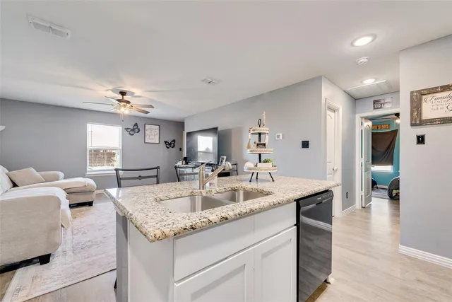 a view of living room kitchen island furniture and wooden floor