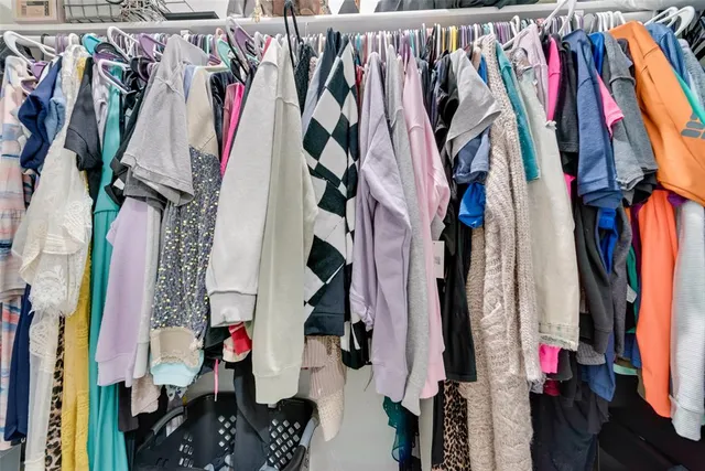 a view of walk in closet with clothes