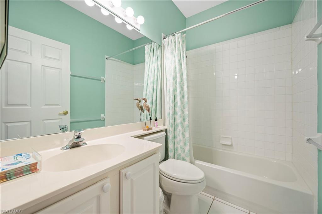 1742 Marsh Run Naples, FL 34109 - Photo 12 of 31 a bathroom with a granite countertop sink a toilet and shower