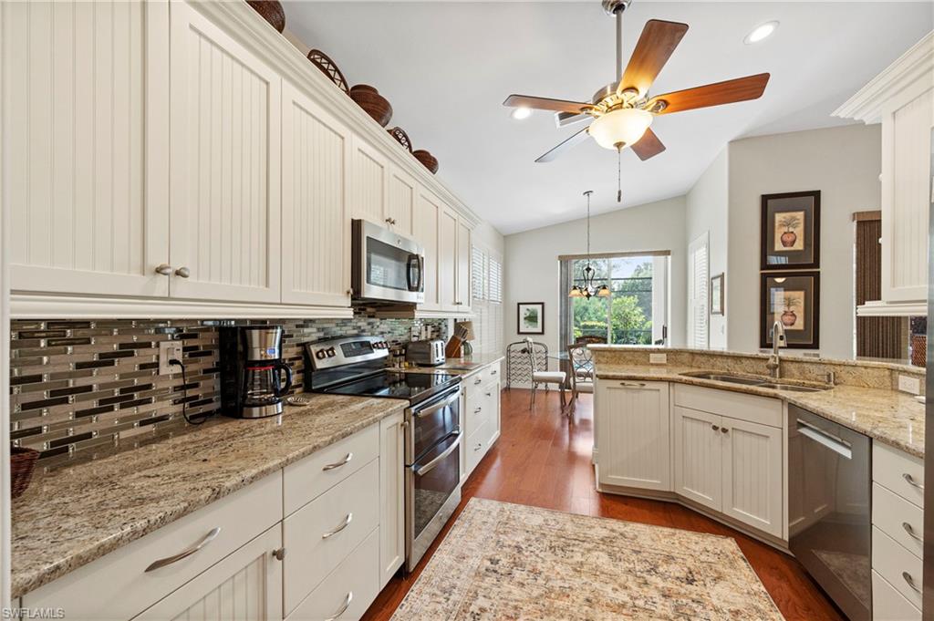 1742 Marsh Run Naples, FL 34109 - Photo 15 of 31 a kitchen with stainless steel appliances granite countertop a sink a stove and cabinets