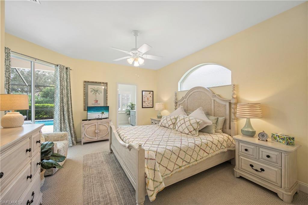 1742 Marsh Run Naples, FL 34109 - Photo 19 of 31 a bedroom with a bed and a chandelier